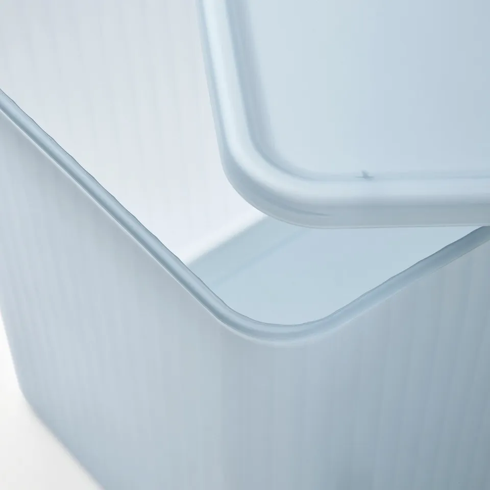 Clear plastic container with lid, showing smooth edges and semi-transparent sides.
