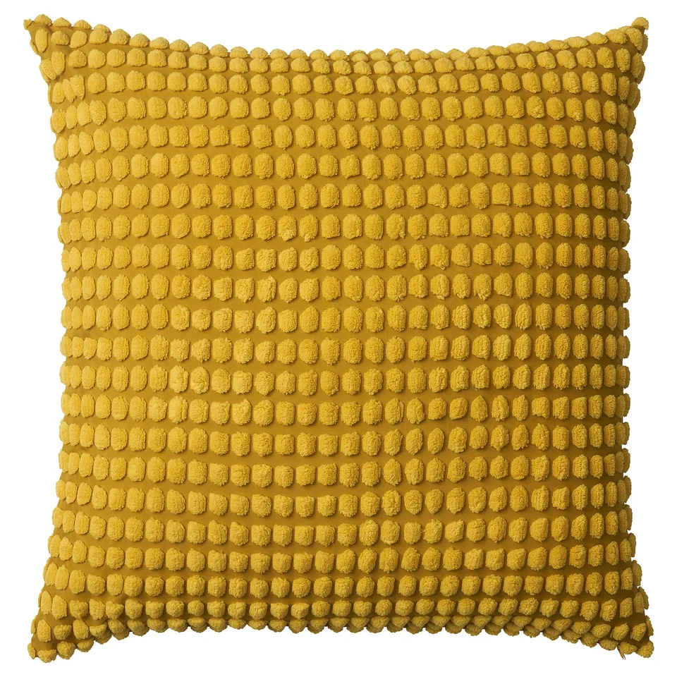 Square, yellow, textured throw pillow with rounded bumps, made from recycled polyester.