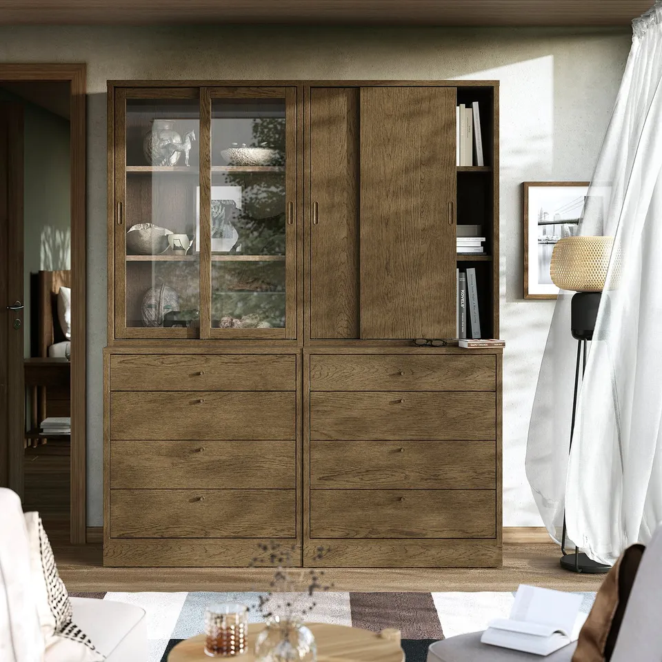 Large oak TONSTAD storage unit in minimalist living room with sofa and lamp.