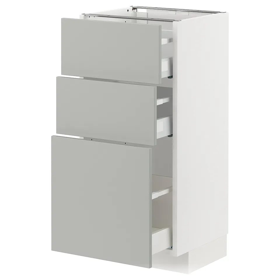 A white METOD kitchen cabinet with grey havstorp drawers, featuring a modern clean design and made from durable materials.