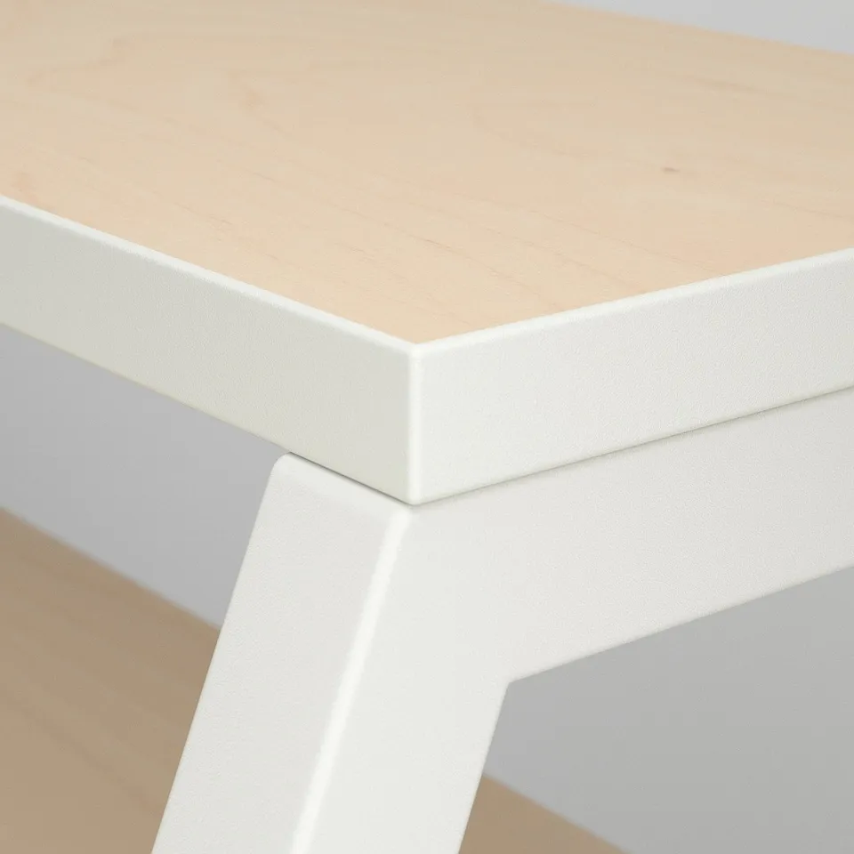 A sleek, modern desk with a smooth, light wood top and crisp white edges, showing fine craftsmanship and quality materials.