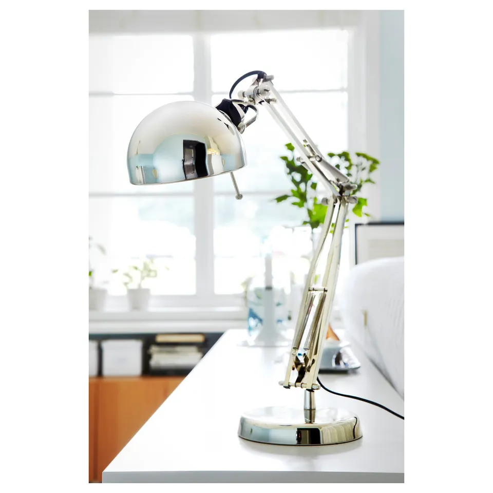 Modern metallic desk lamp with adjustable arm and shade providing directed light.