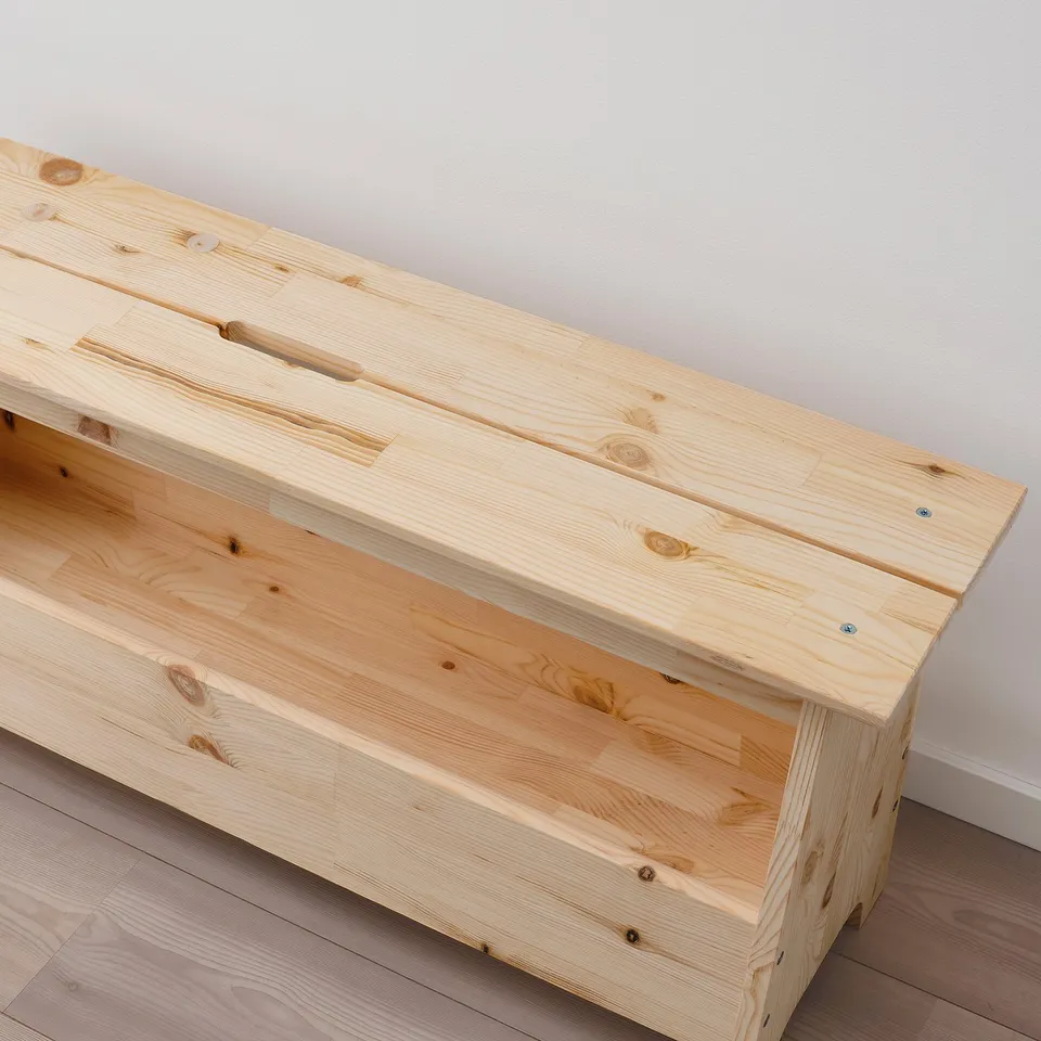 Natural wood bench with visible grain, sturdy construction, and cut-out handles for easy movement.