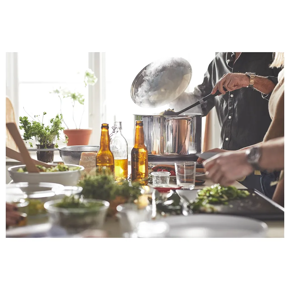 Person cooking in a well-equipped kitchen.