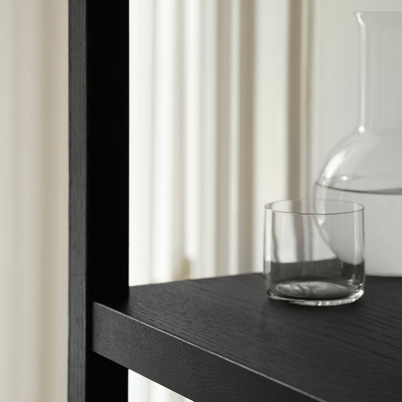 Wood shelf with jar & cup by window.