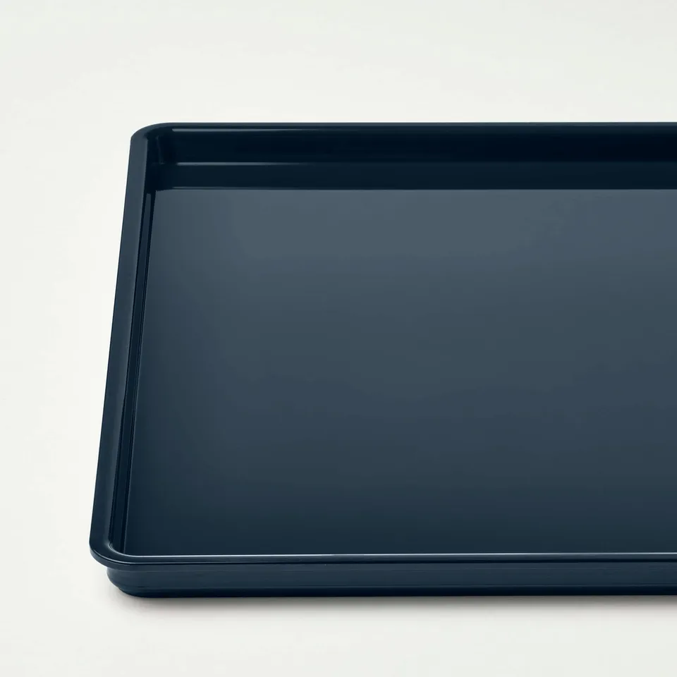 Dark blue rectangular plastic tray, smooth surface, clean and undamaged.