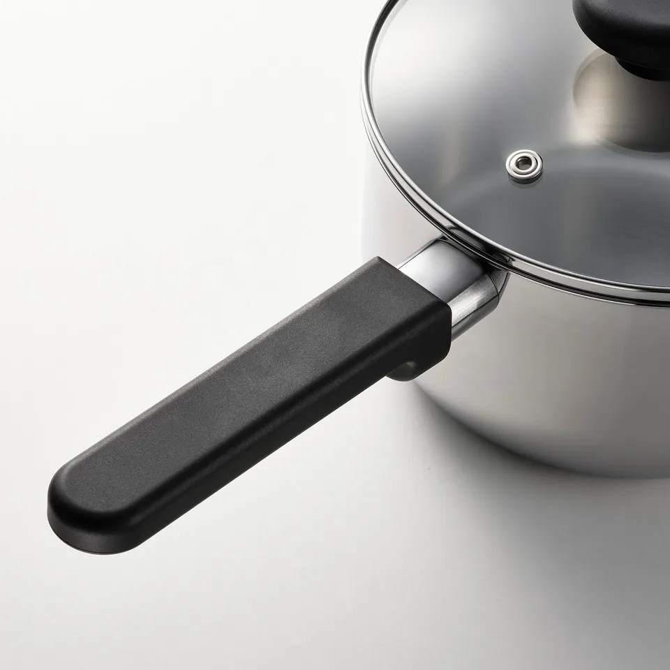 Modern saucepan with black handle and glass lid; stainless steel, durable, easy to clean.