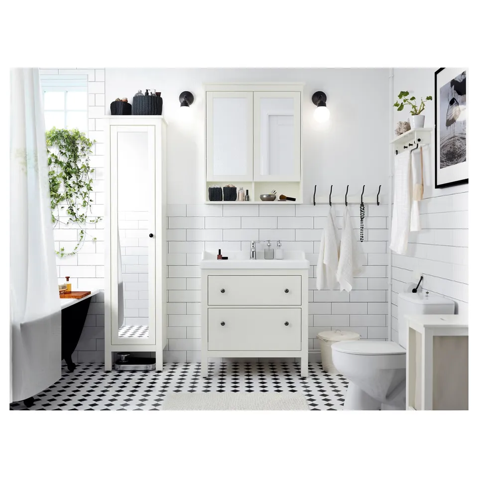 Modern white bathroom with black accents, featuring HEMNES cabinet, full-length mirror, sink, toilet, shower, and geometric floor tiles.