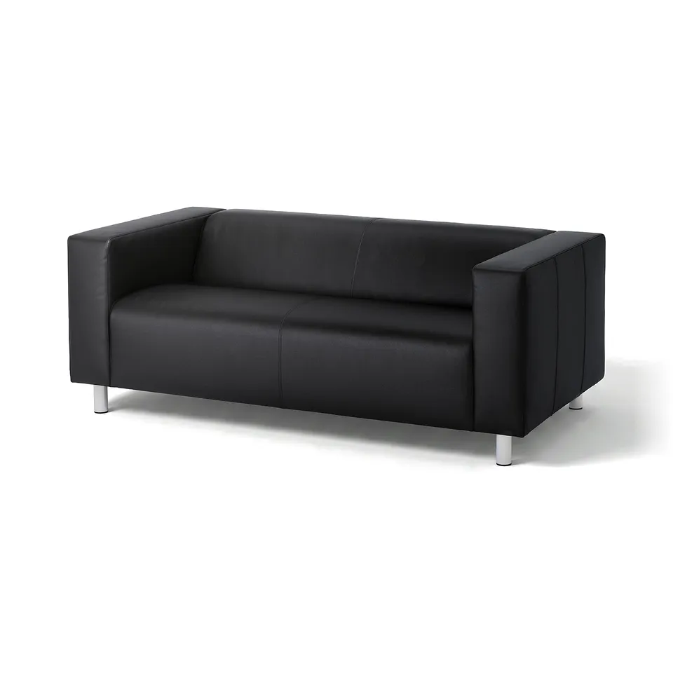 Black leather sofa, modern design, clean lines, raised on metal legs, square cushions.
