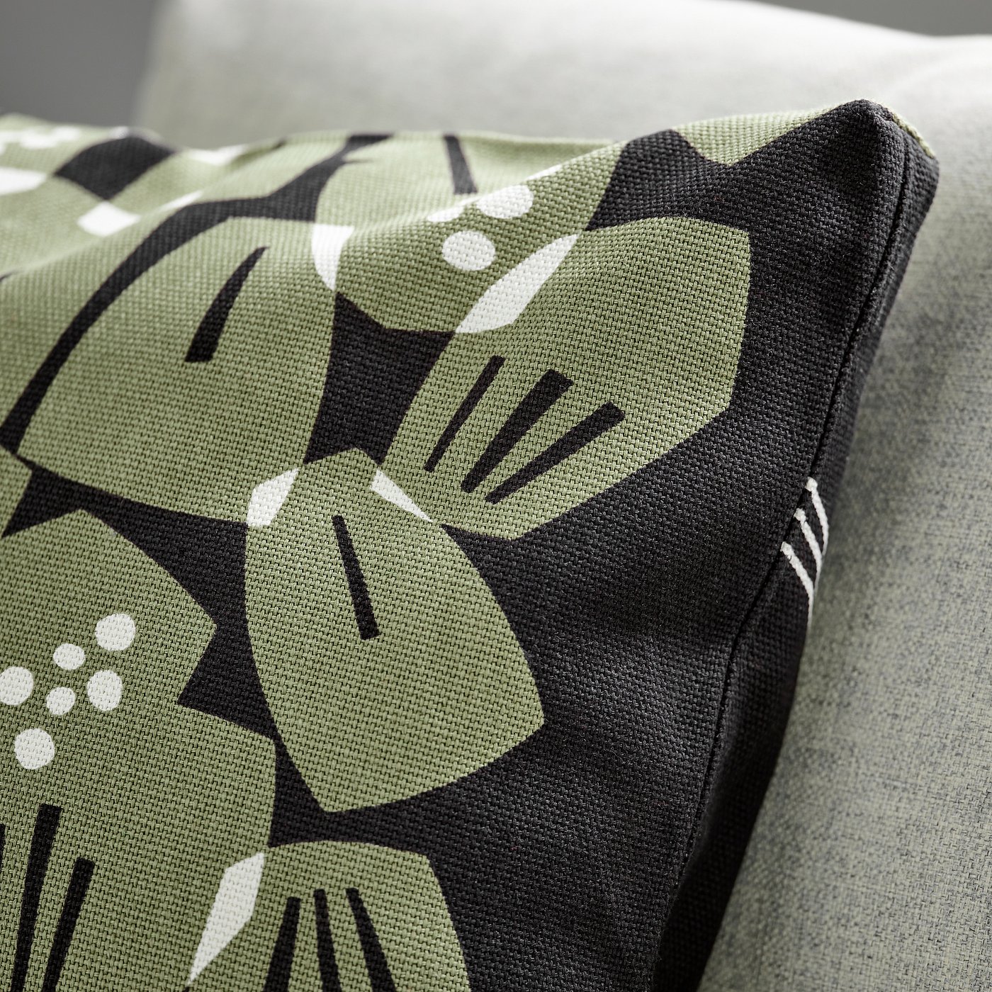 Pic: modern cushion with abstract green leaf print, thick texture, zip closure.