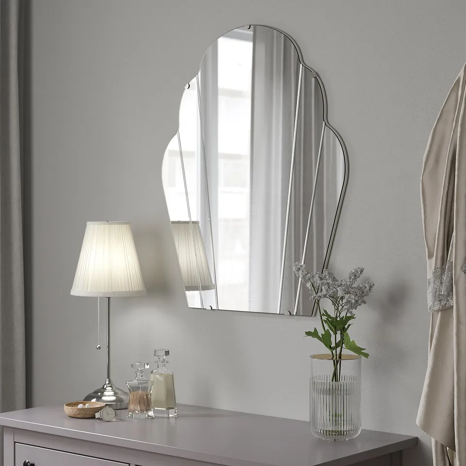 LOMMARYD mirror, lamp, vase on table. Mirror large, reflective, focal point.