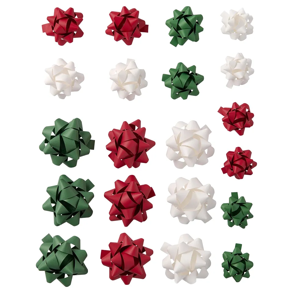 Collection of colourful star-shaped bows in red, green, and white, made of paper, arranged on white background.