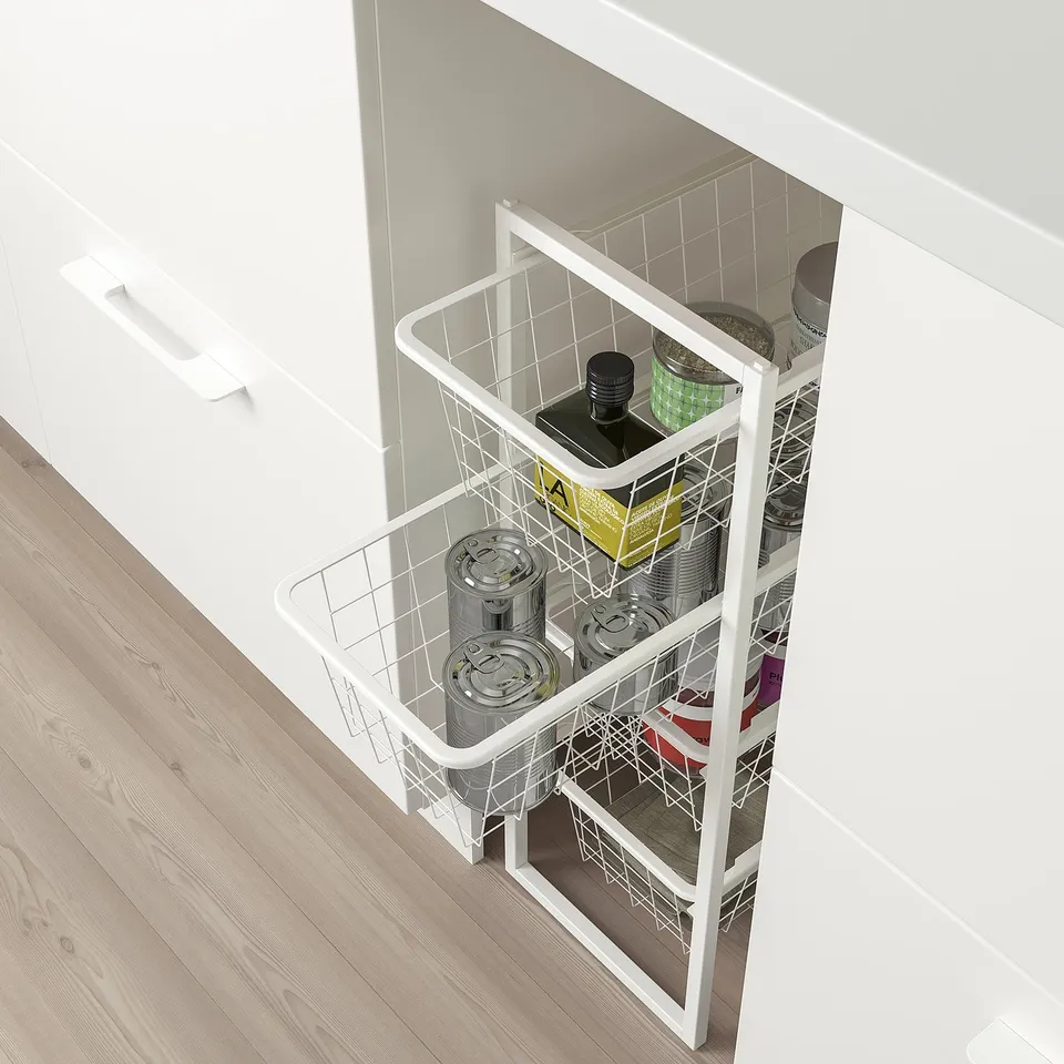 Open white cabinet with wire storage baskets holding cans and bottles.