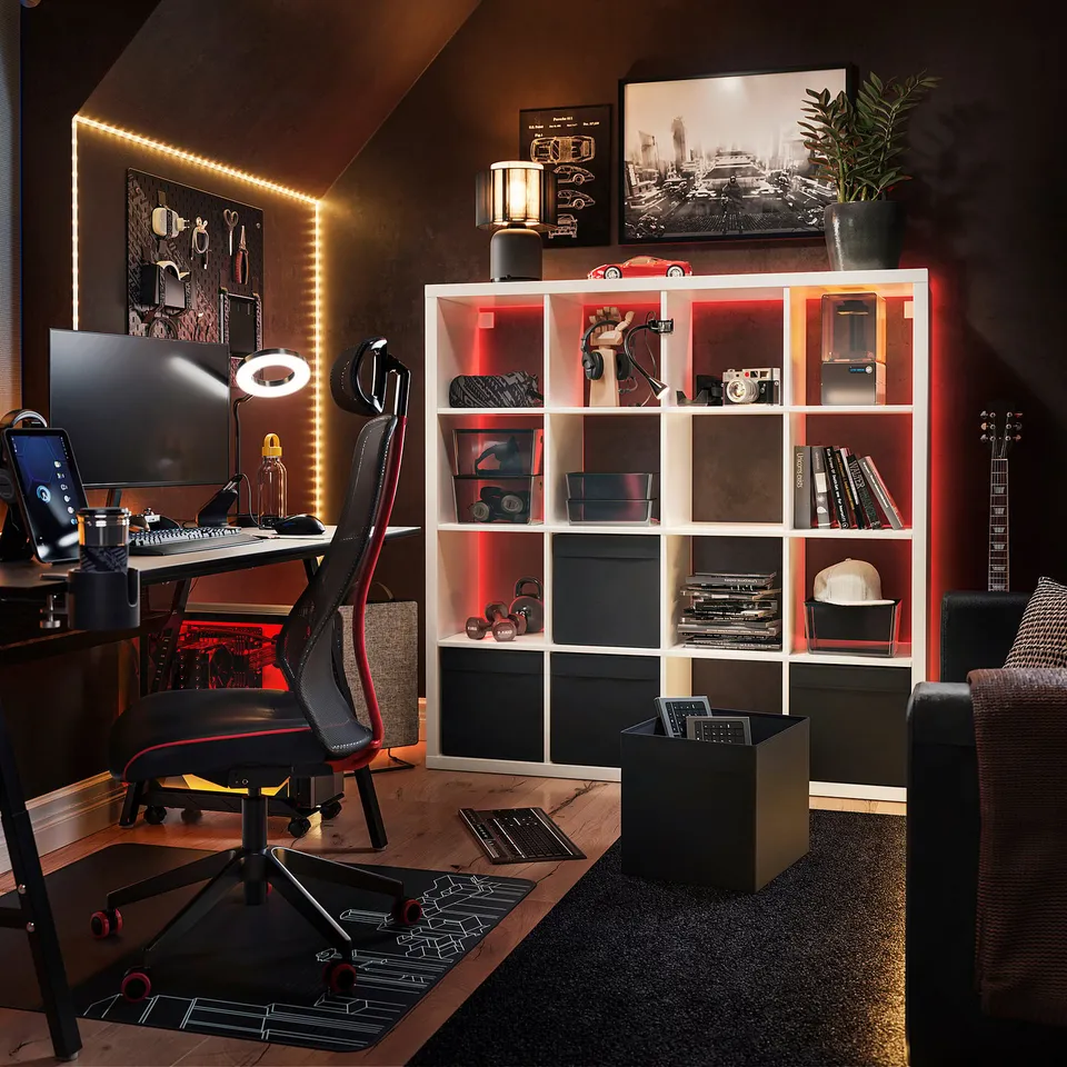 Modern home office featuring a black and red KALLAX shelving unit with led lights, a sleek desk, and electronic equipment.