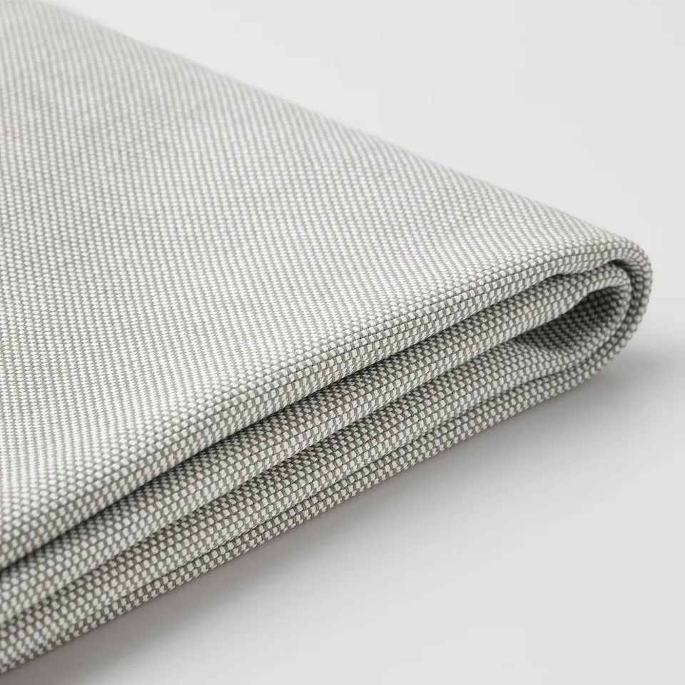 Close-up of smooth, grey fabric dining chair cover with subtle weave pattern.