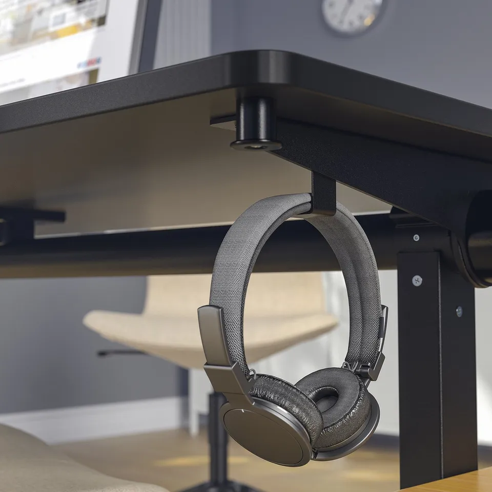Headphones hang securely on table hook, keeping them easily accessible.
