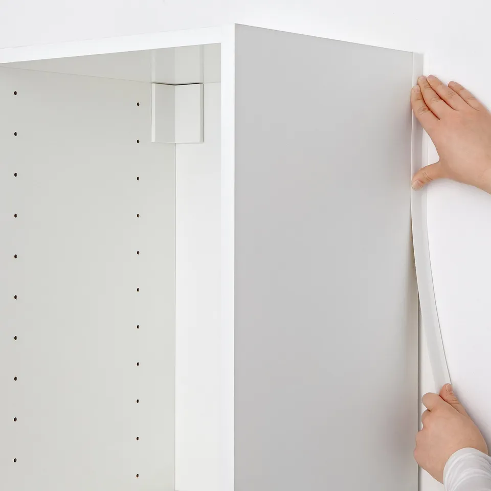 Applying cabinet edge cover.