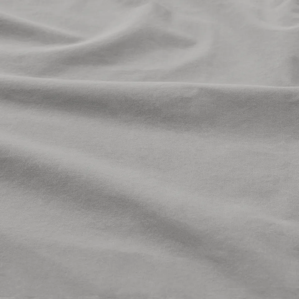 Soft, textured cotton pillowcase in neutral tone, showcasing quality fabric.