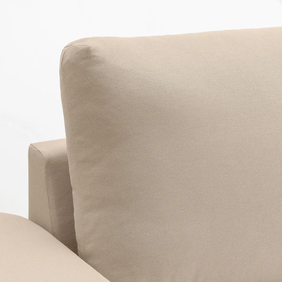 Neutral-toned sofa with soft, textured fabric, plush cushions, and sturdy armrests. Ideal for comfort and durability.