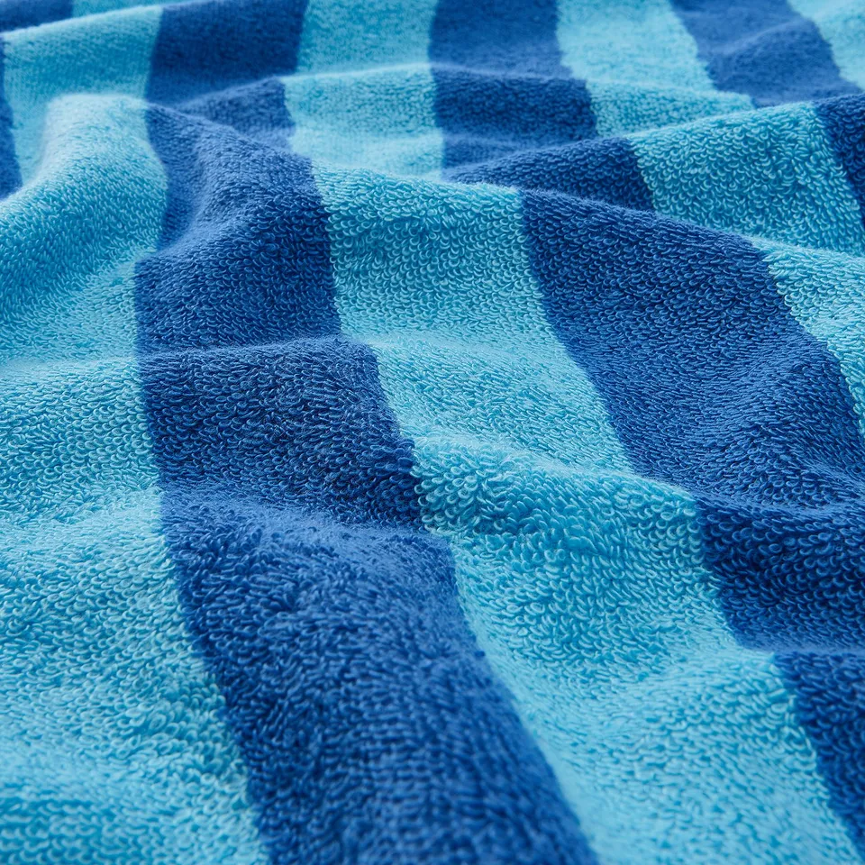 Close-up of plush towels with bold stripes, revealing soft texture and high absorbency.