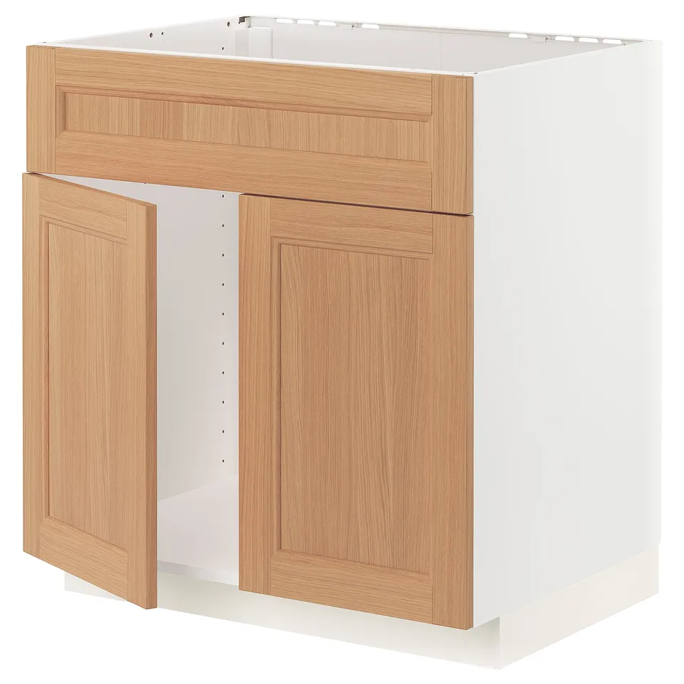 A METOD kitchen cabinet in light oak. It two doors and a drawer, with a sleek, wooden finish and sturdy frame construction.