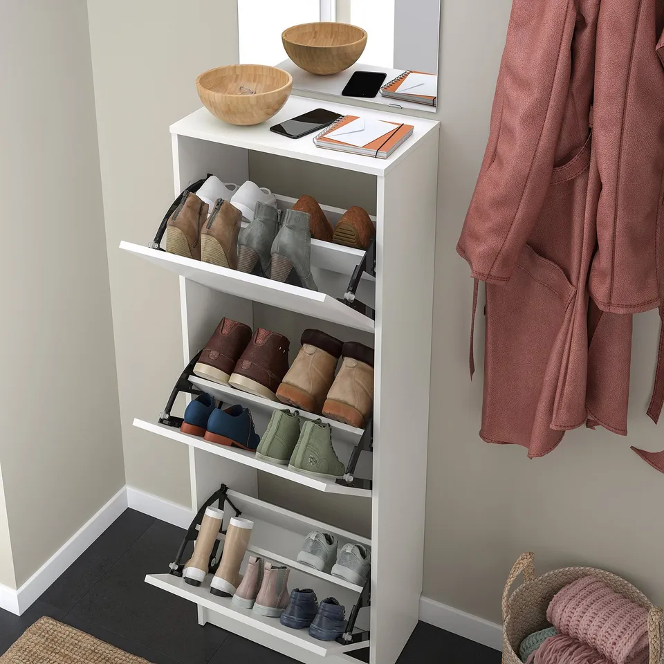 White shoe cabinet, BISSA, stores about 12 pairs, saving floor space. Adjustable compartments, ventilated, fits tight against wall.