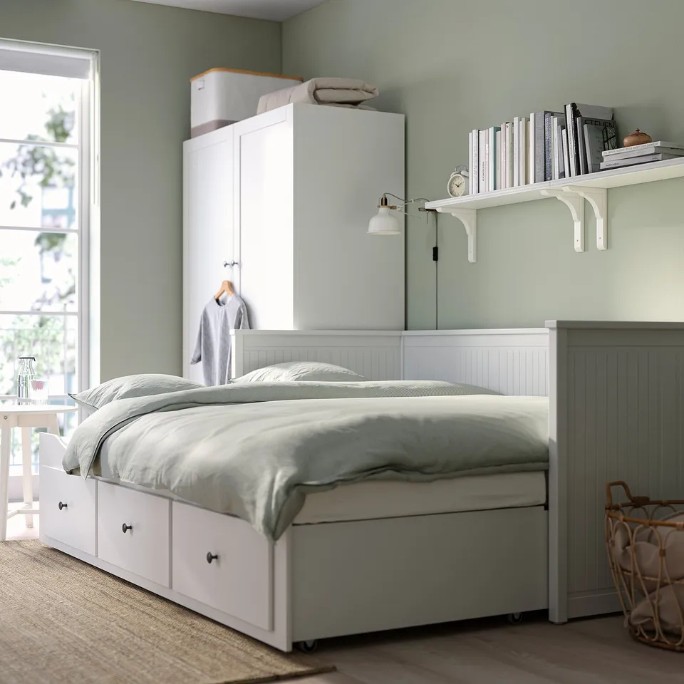 Convertible sofa-bed with storage drawers.