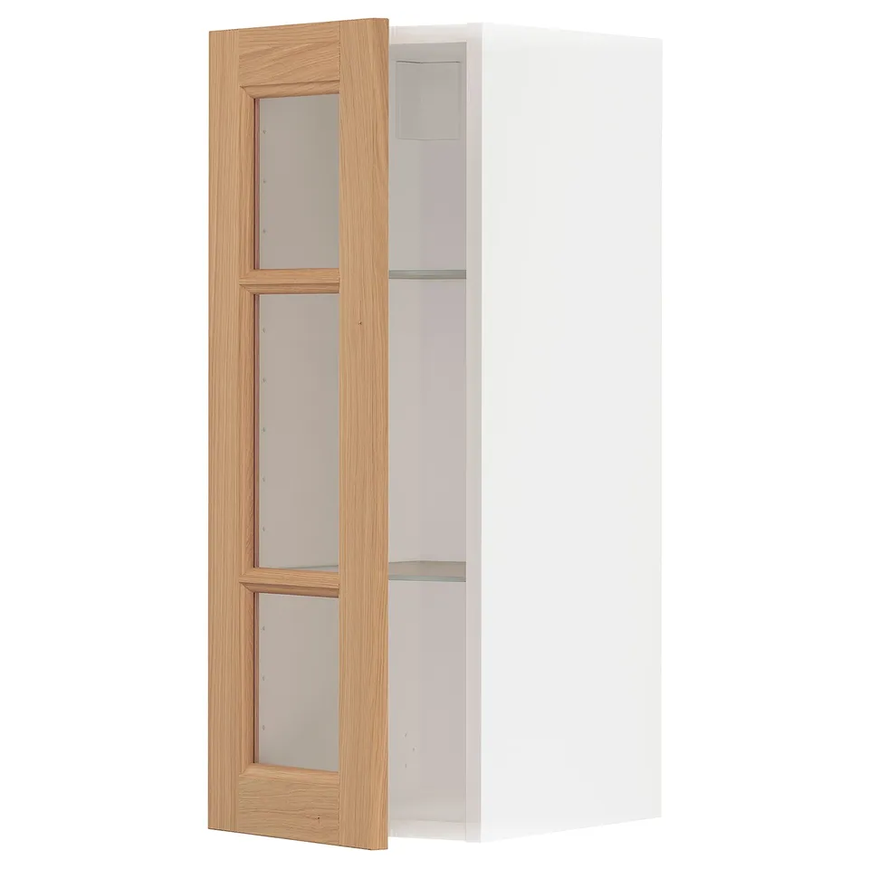 Open white kitchen cabinet with oak door and glass panels.