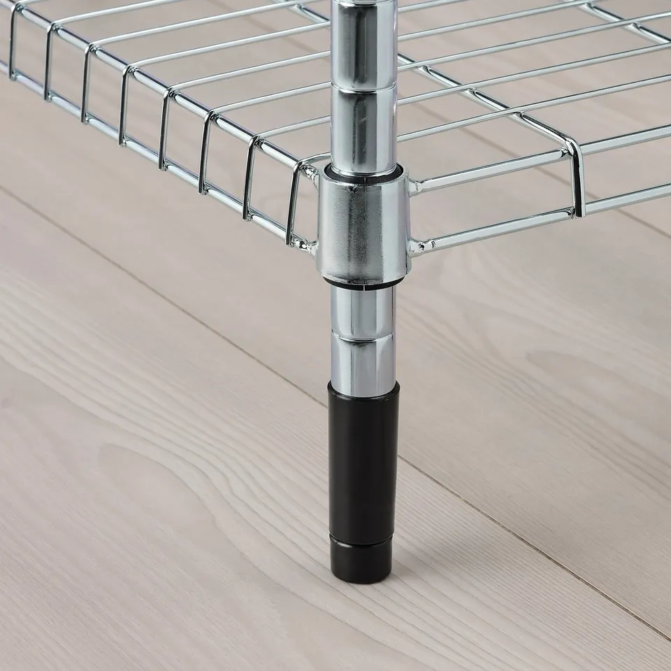 Close-up of sturdy metal shelf support with adjustable, black-capped legs on wooden floor.
