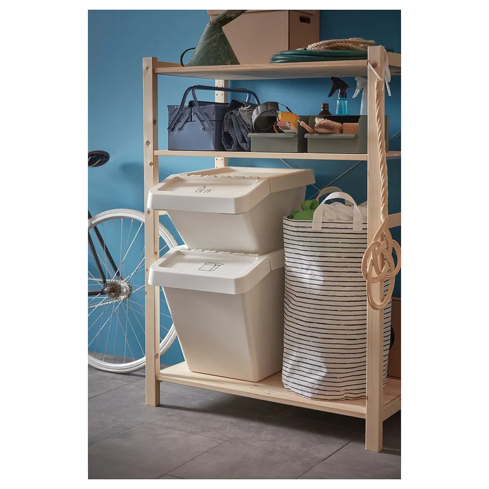 Wooden storage shelves with a white bin and striped fabric bag.