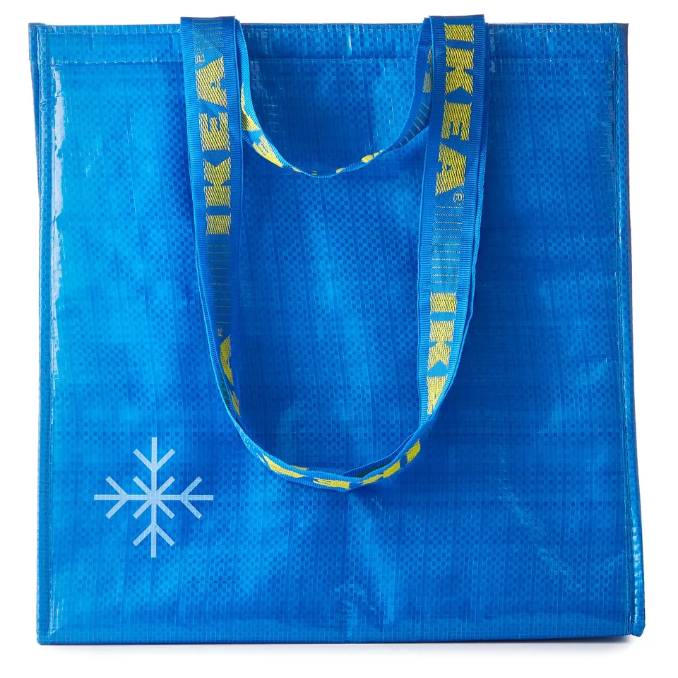 Blue reusable shopping bag with yellow handles and a white snowflake logo. Made from recycled polypropylene and polyester.