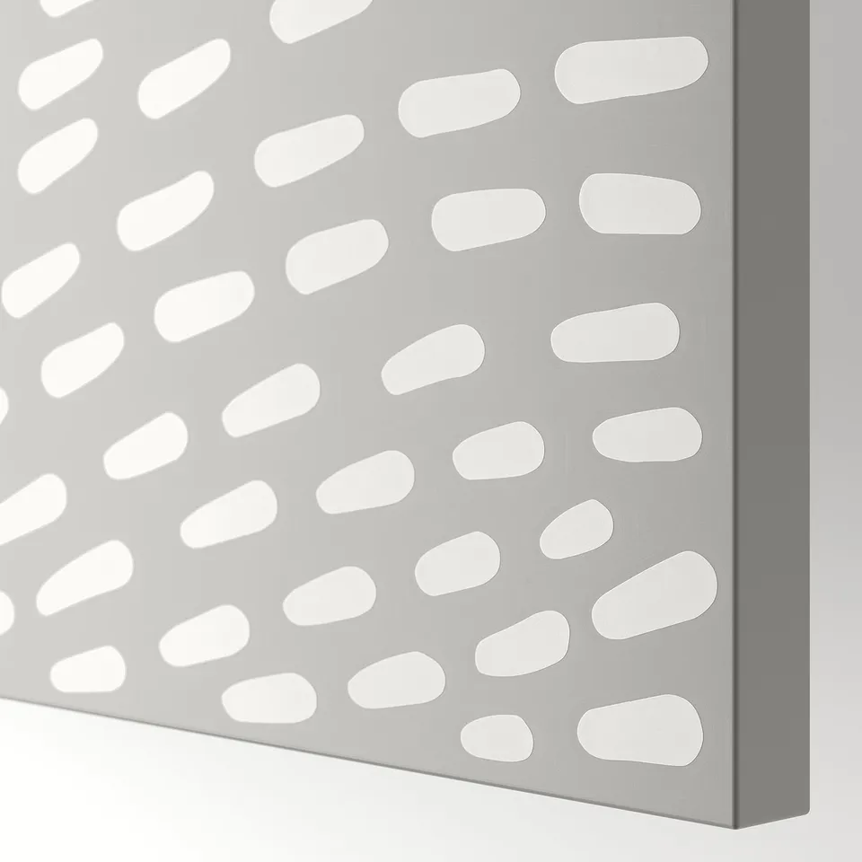 Close-up view of a modern grey door with evenly spaced circular cutouts, showcasing its sleek and minimalist design.
