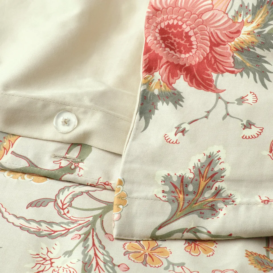 Floral pillowcase with button closure. Smooth, breathable fabric.