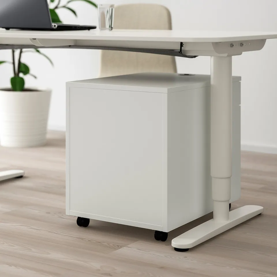 White mobile storage unit with lock, fitted under adjustable desk, on wheels, part of GALANT series.