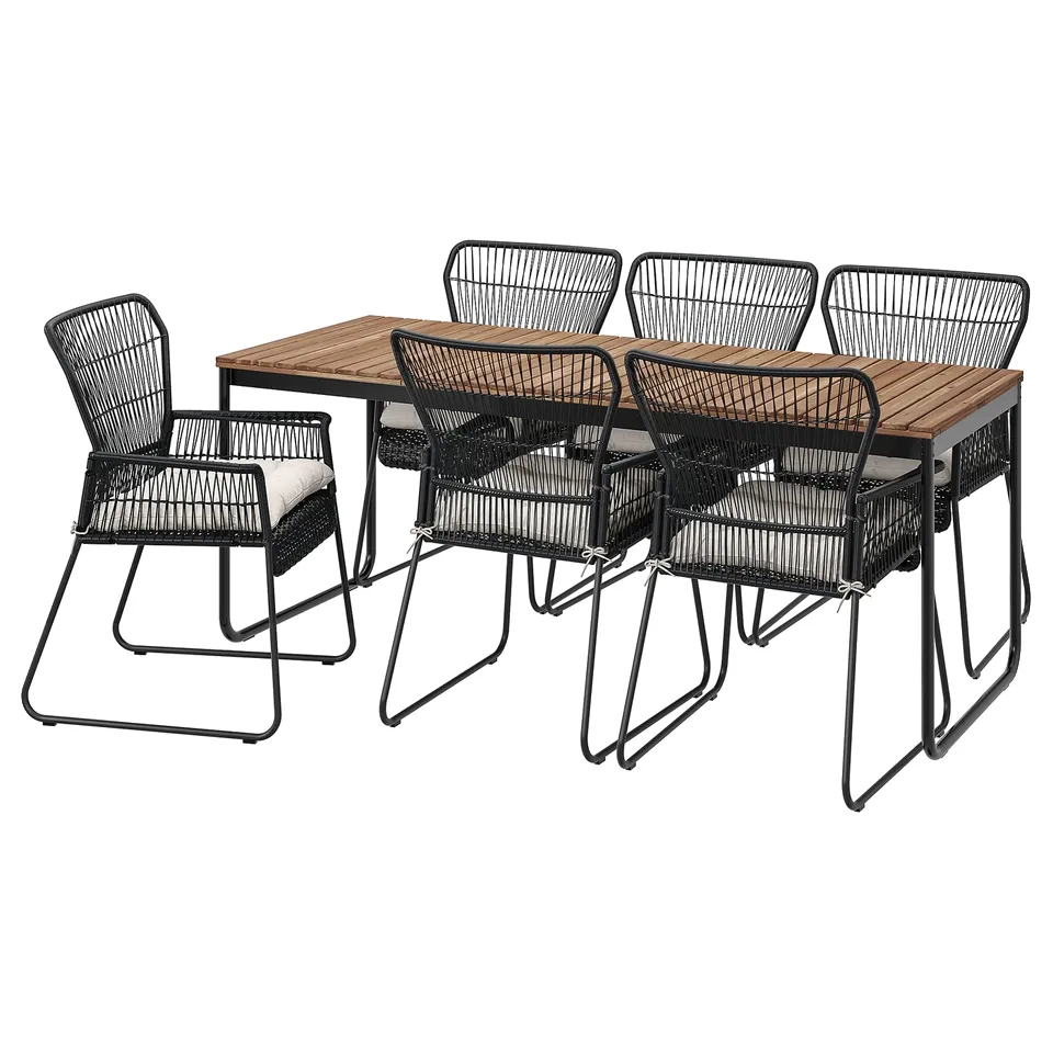 Black outdoor dining set with rectangular table and six wicker chairs. Durable materials, sleek, modern design.