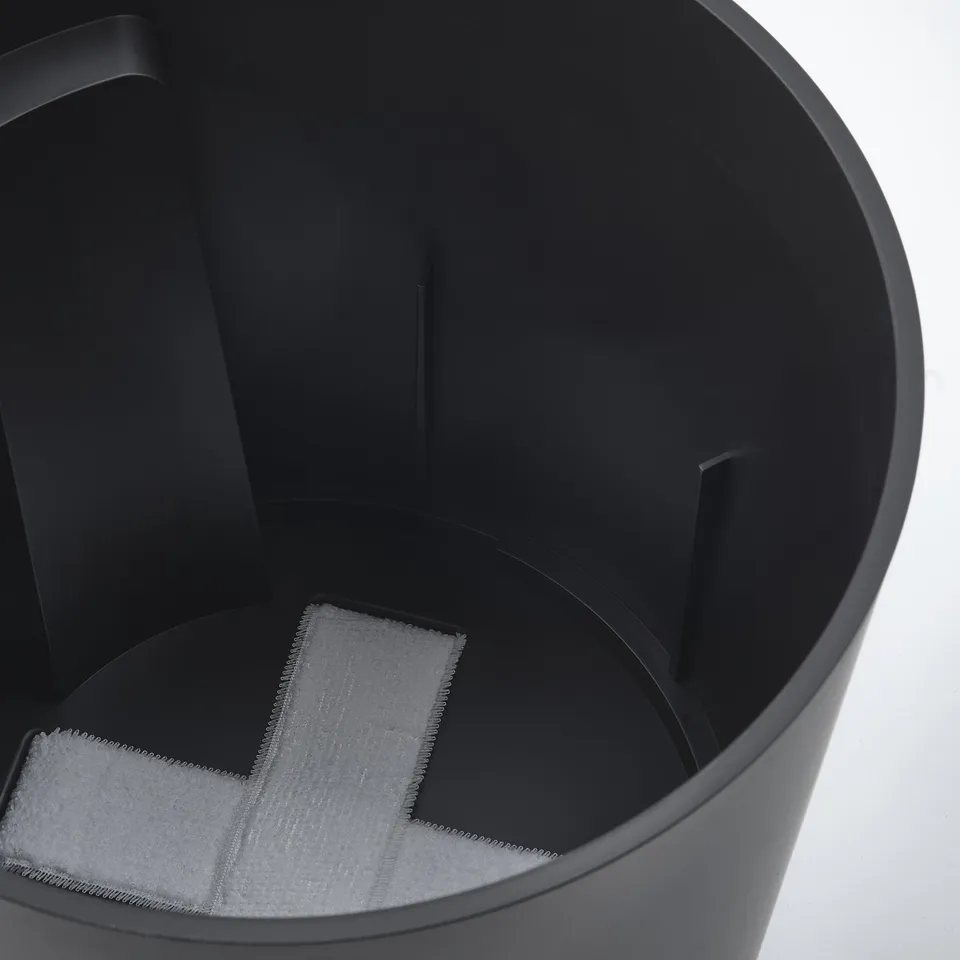 Black self-watering planter with visible wick, designed for easy plant care.