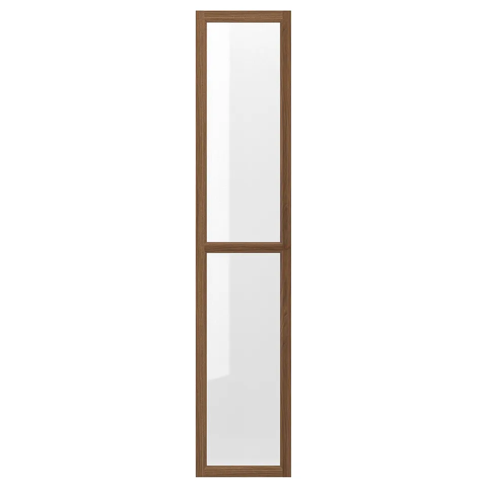 An OXBERG glass door in brown for a bookcase. It a wooden frame and clear glass panels, adding protection and style.