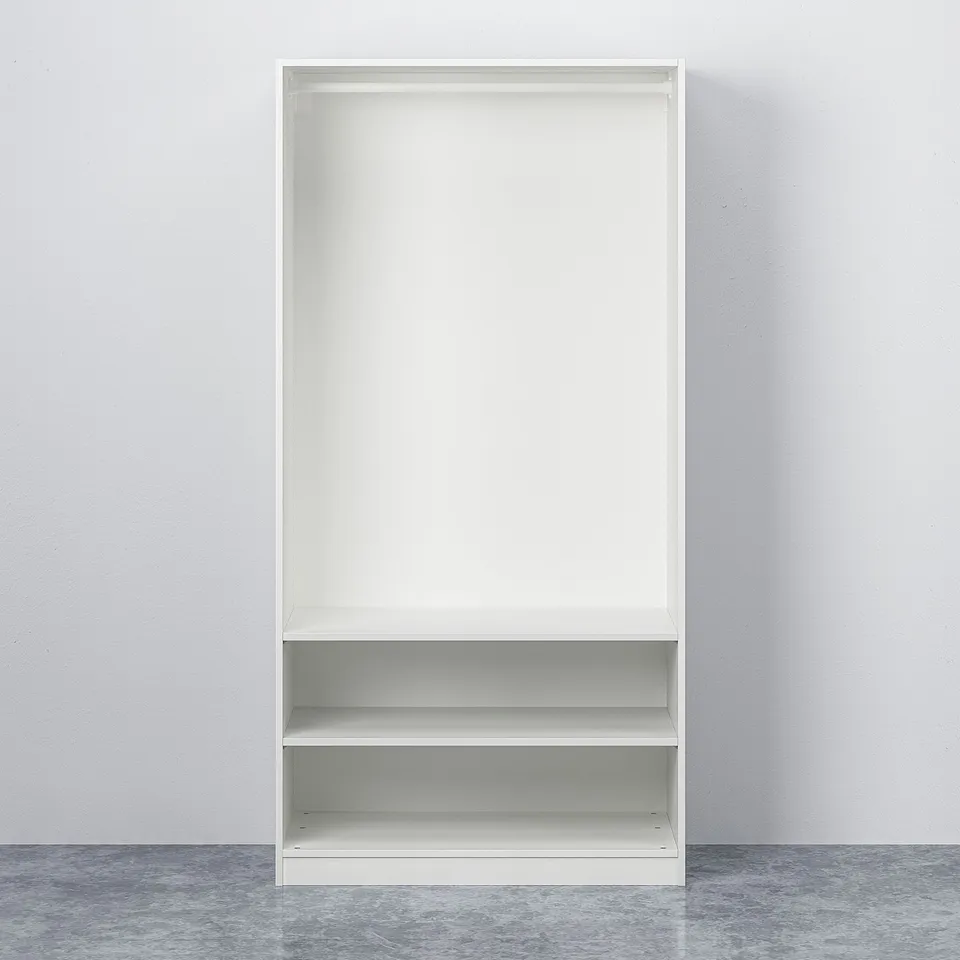 White PAX wardrobe with two shelves and adjustable feet on a grey floor.