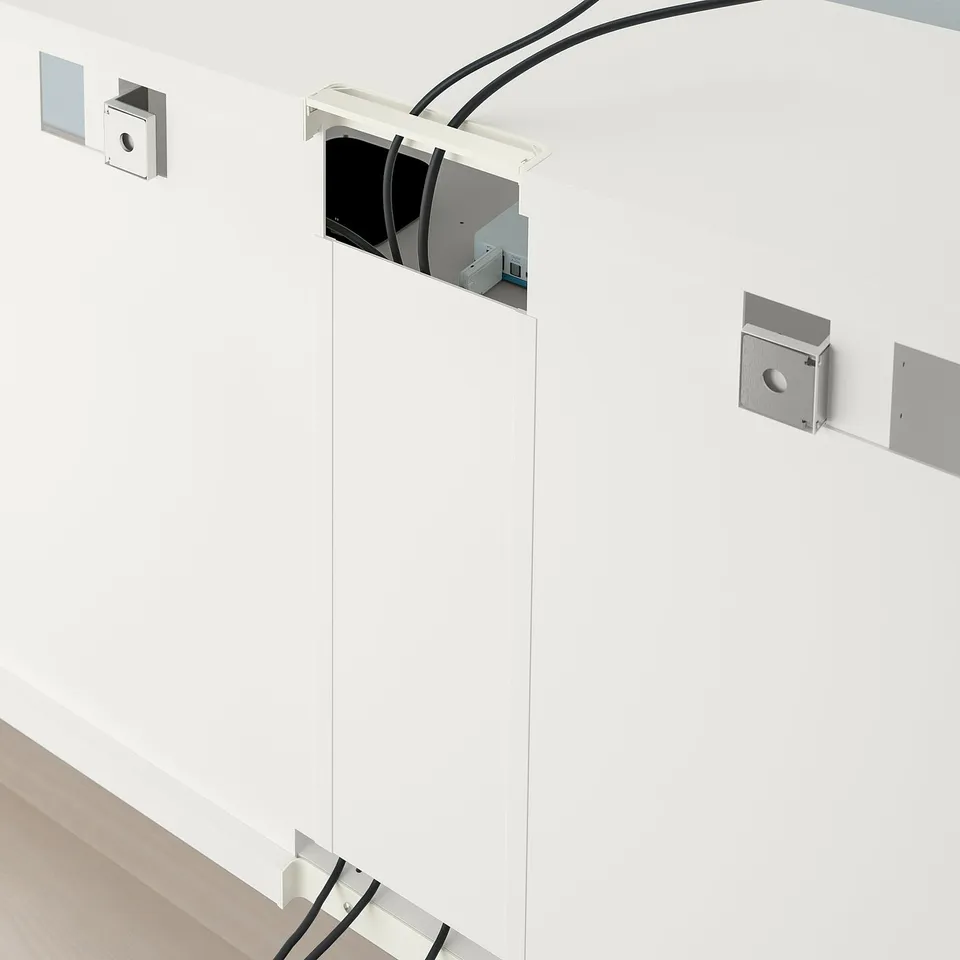 White BESTÅ tv bench with cable management, adjustable feet, and wall anchors.