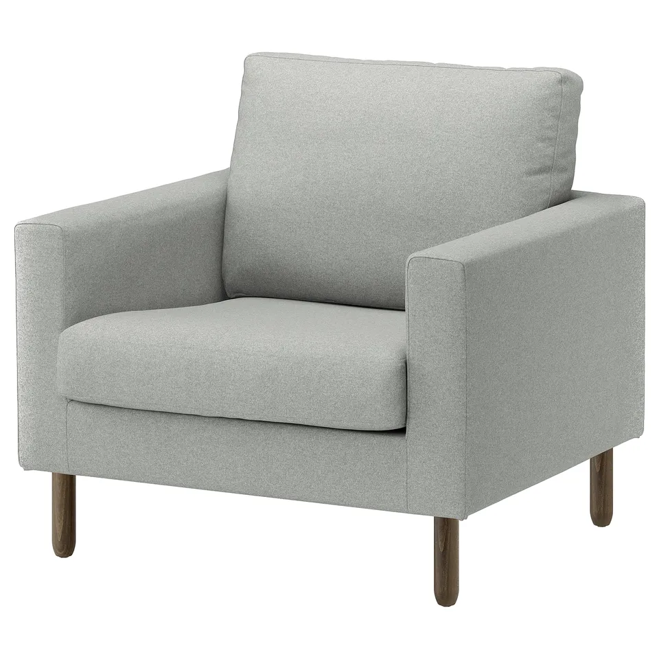 A grey SALTSJÖBADEN armchair with wooden legs. Modern, sleek design, soft cushions for comfort.