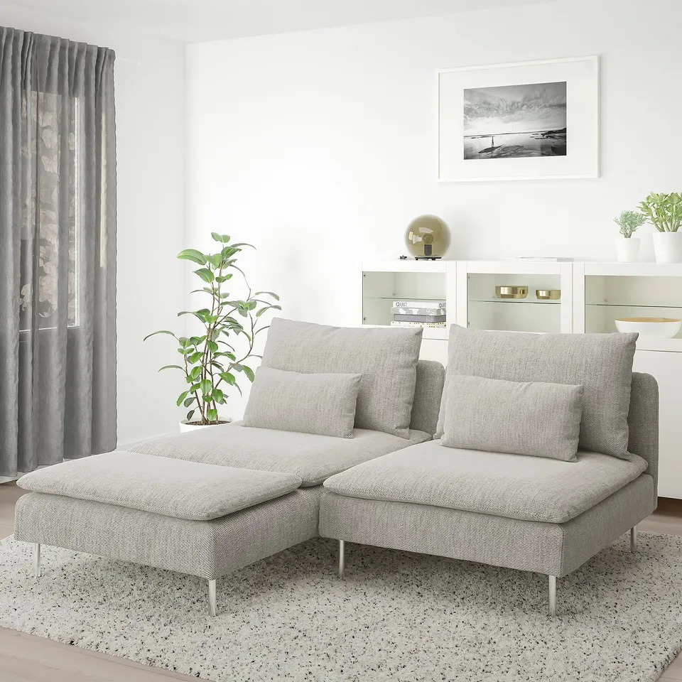 SÖDERHAMN sofa, light grey, with a chaise longue. Modern, low profile design. Large compared to plant and curtains.