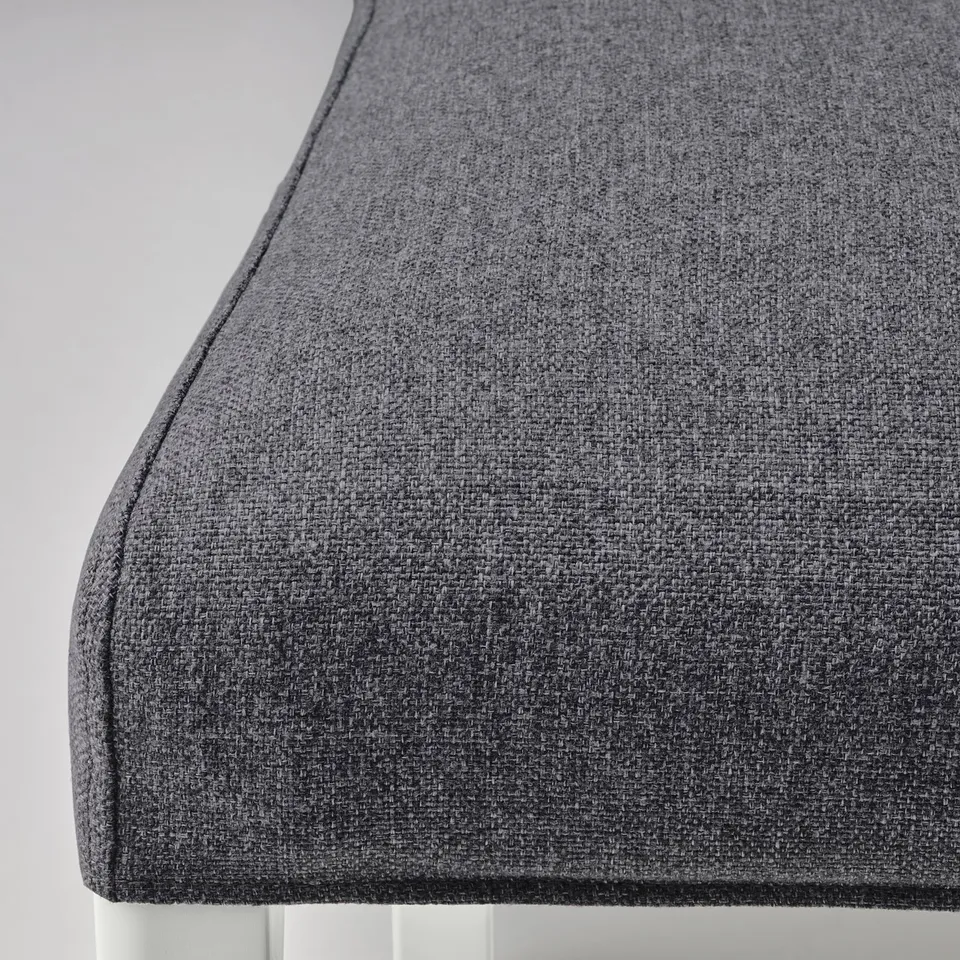 Close-up of a grey fabric chair, showcasing its fine texture and stitching.
