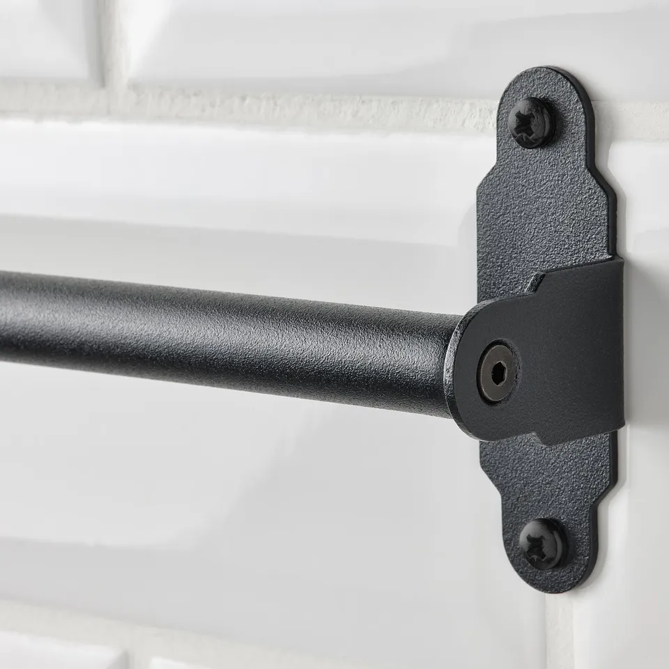 Black metal rail bracket mounted on white wall, part of HULTARP series, designed for hanging kitchen accessories.