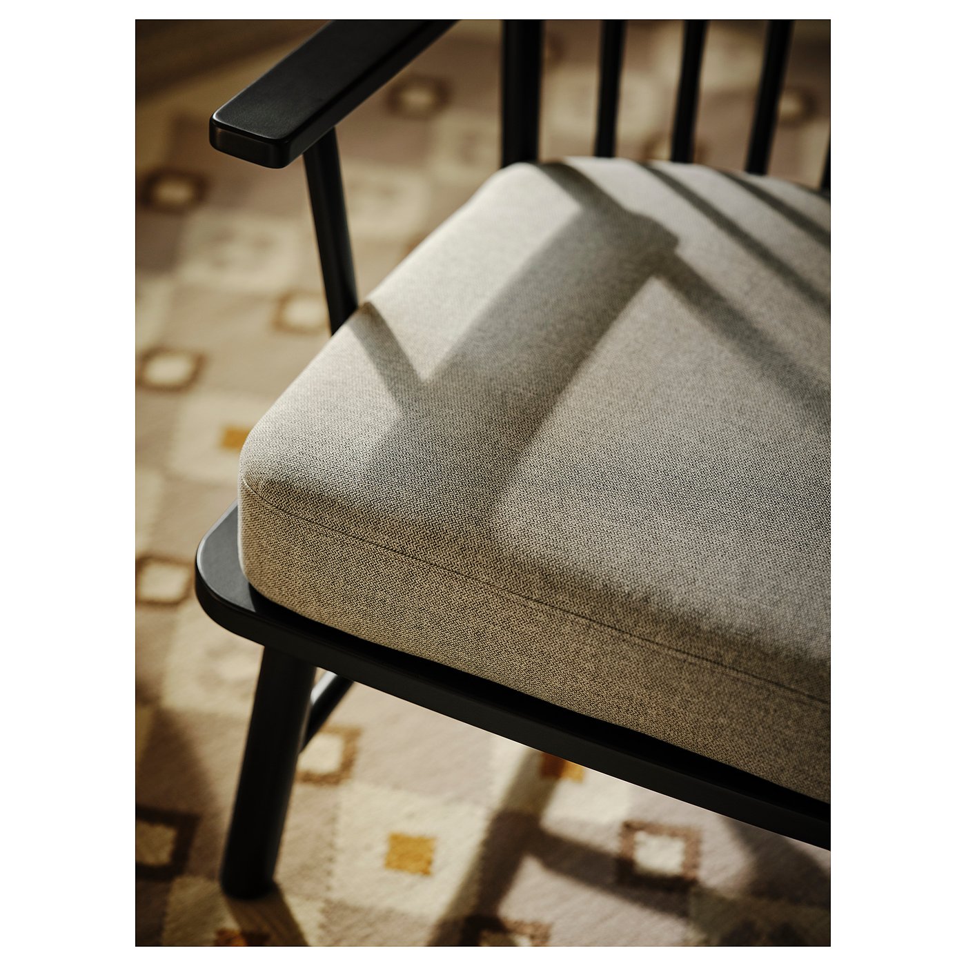 PERSBOL spindle armchair in beige fabric with dark wood frame.