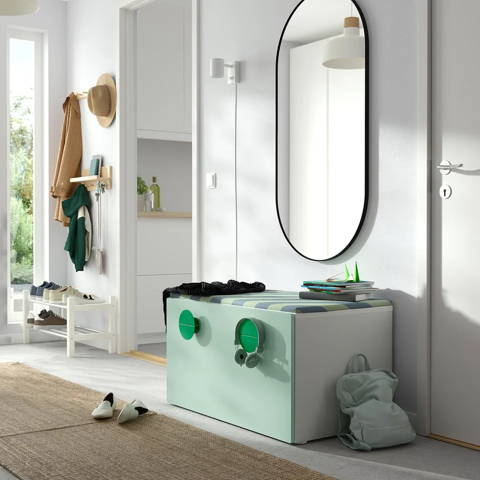 Modern entryway with mirror, SMÅSTAD bench with toys, coat rack, and shoe rack.