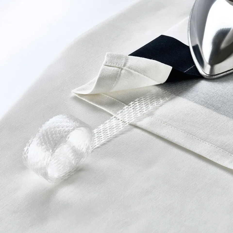 Curtain eyelets on white fabric let it glide smoothly.
