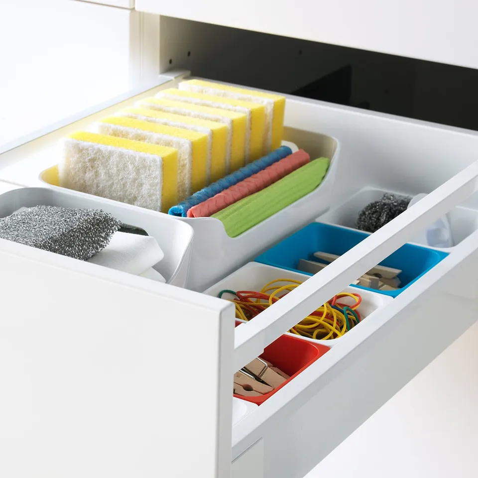 Drawer with sponges, rubber bands, clips, blue/green trays, fully extends, quiet close.