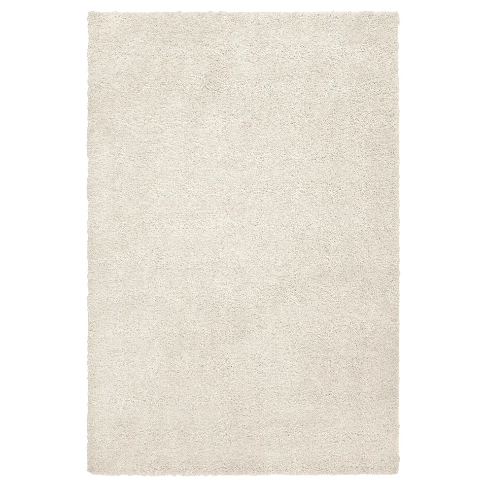 A soft, off-white area rug named ÄRENDE, rectangular in shape, with a thick, textured pile for comfort.
