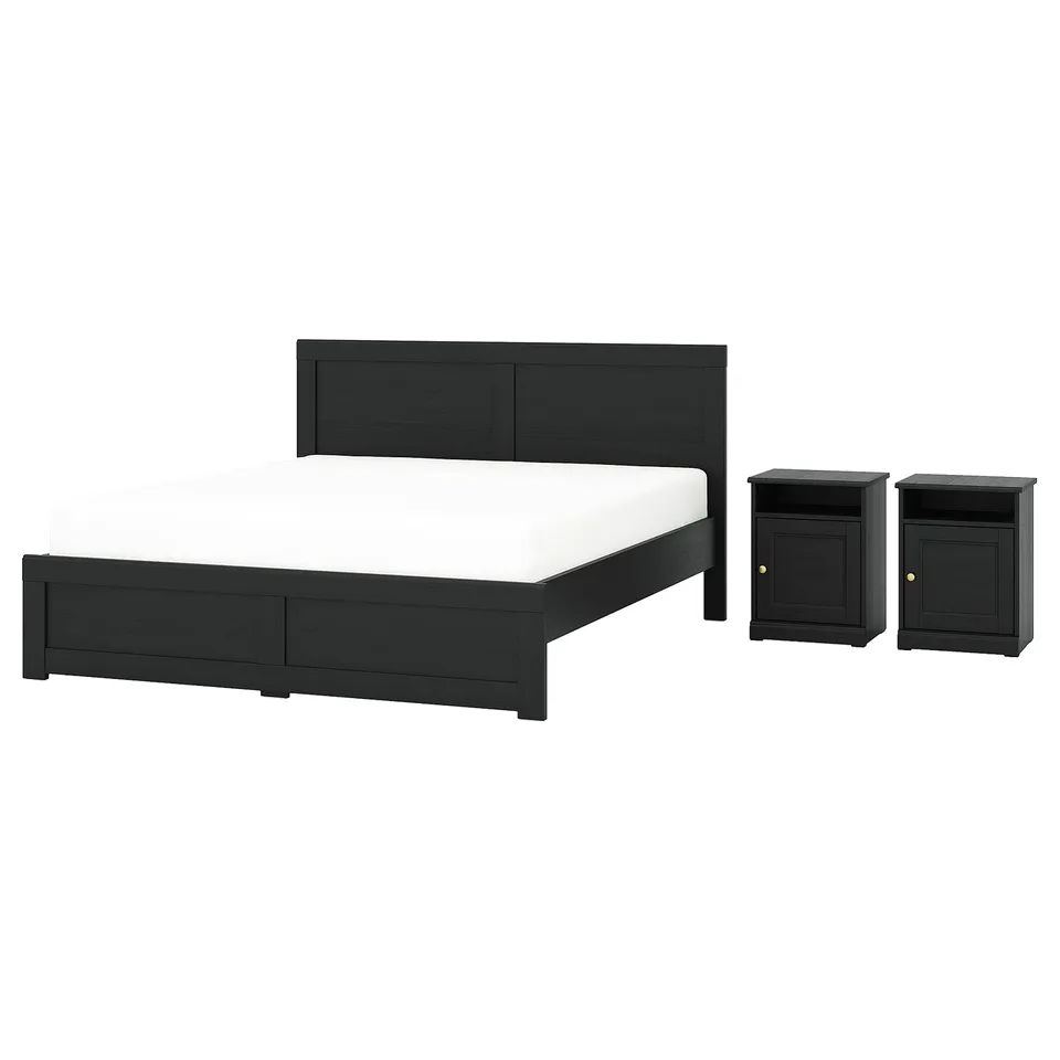 Black bed set with headboard, footboard, and nightstands. Traditional design with brass knobs.