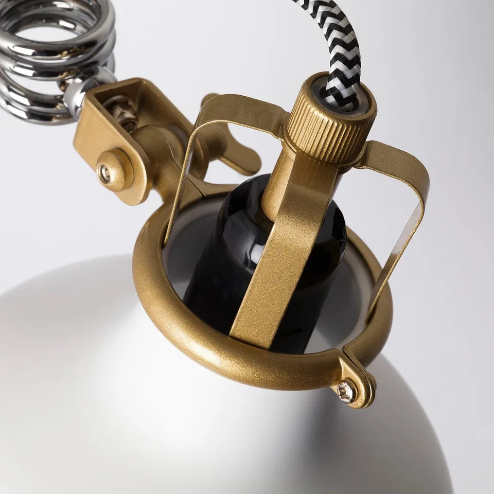 Golden adjustable lamp clamp with black cable, secures firmly, high-quality metal finish.